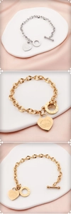 Detail of titanium steel bracelets featuring heart charms and engraved Bible verses