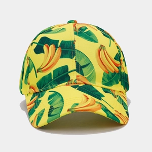 Close-up of tropical banana and green leaf print on a vibrant yellow baseball cap