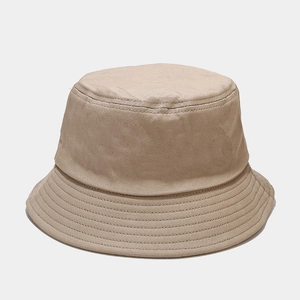 Detail of light khaki cotton bucket hat featuring reinforced stitching and twill texture