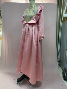 Close-up of pink satin evening dress featuring intricate silver sequin floral patterns