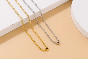 Detailed view of hammered gold and silver titanium steel link necklaces with lobster clasps