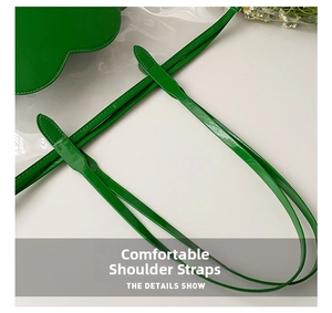 Detail showing high-quality stitching on green leather shoulder strap with macro view