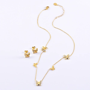 Elegant gold butterfly jewelry set including a shell necklace and matching stud earrings