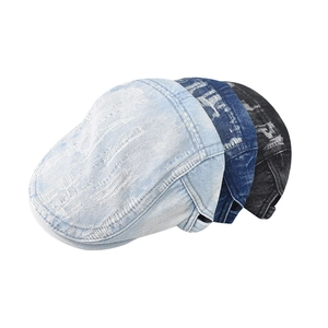 Three distressed denim flat caps in light blue, dark blue, and black grey on white background