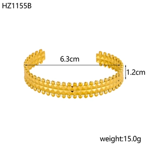 Detail view of a gold-plated stainless steel cuff with rivet patterns and size specifications