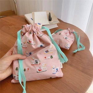 Detailed view of pink cotton drawstring bags with cute duck and animal boat prints