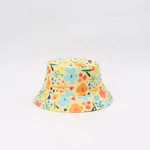 Detailed macro view of yellow cotton sun hat with vibrant floral print and wide brim
