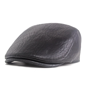 Detailed side view of black leather flat cap showing natural lychee texture and stitching