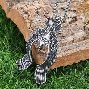 Close-up of flying eagle pendant showing detailed feather textures and silver finish