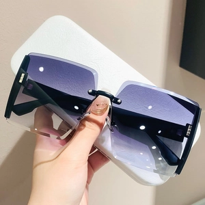 Detailed close-up of fashion oversized square rimless sunglasses with purple gradient lenses