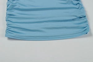 Close-up of light blue bodycon dress featuring side ruching and double-needle hem detail