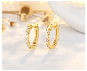 Close-up of gold-plated hoop earrings featuring micro-paved white zircon stones