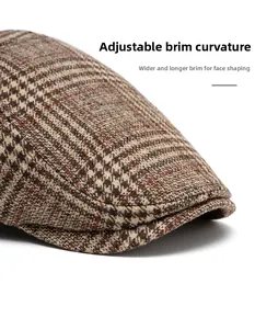 Detail of classic brown houndstooth flat cap featuring a foldable and widened brim design