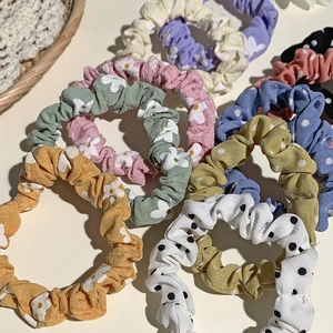 Assorted vintage floral and polka dot fabric scrunchies in various pastel colors