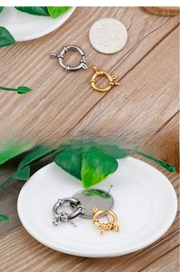 Detail of round gold and silver spring clasps with decorative texture for DIY jewelry