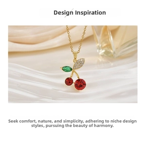 Detail of elegant cherry pendant necklace with red crystals and gold chain on silk