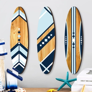 Three-piece wooden surfboard wall decor set with blue and white geometric coastal patterns