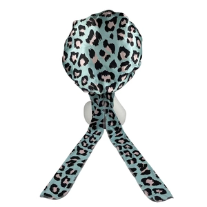 Leopard print satin sleep bonnet in blue with long ribbons on a white mannequin head