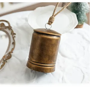 Vintage bronze metal bell with textured finish and jute rope for holiday home decor