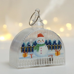 Close-up of LED Christmas snowman lantern with festive patterns and golden warm bokeh light