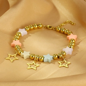 Detailed view of gold beaded bracelet with colorful resin stars and hollow star charms