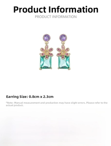 Detail of floral earrings with purple zircon flower and mint green crystal pendant