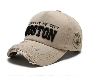 Detail of distressed khaki baseball cap with Boston embroidery and vintage side logo