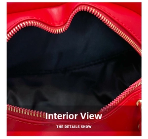 Macro view of red heart-shaped bag interior with black lining and gold zipper detail