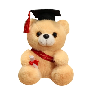 Fluffy graduation teddy bear with black mortarboard and congratulations sash on white background