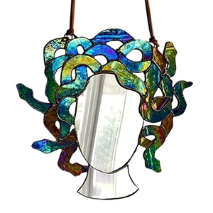 Detailed close-up of rainbow Medusa stained glass wall hanging with gold and blue tones