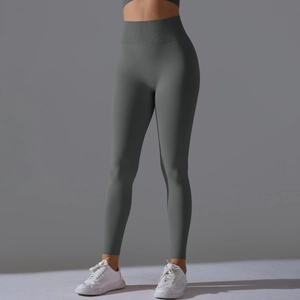 Detail view of the wide ribbed high-waist band on gray-green seamless yoga leggings