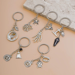 Detailed flat lay of 6 silver metal Halloween keychains with pumpkin and ghost motifs