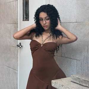 Detail of sexy brown halter neck dress with metallic chain strap decoration on the collar