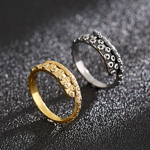 Vintage octopus tentacle rings in silver and gold, featuring realistic sucker textures