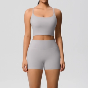 Detail of grey seamless two-piece yoga set with thin straps and high waist shorts