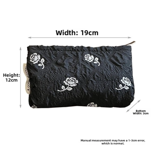 Quilted black makeup bag with white rose embroidery and dimensions 19x12x3cm