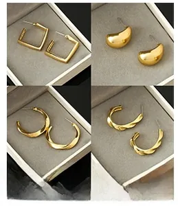 Detail view of four gold geometric earring styles including hoops and textured designs