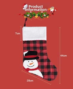 Detail view of snowman embroidery on red buffalo plaid Christmas stocking with white fleece rim