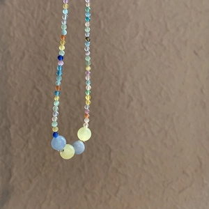Detailed macro view of colorful summer beaded necklace with natural cat eye stones