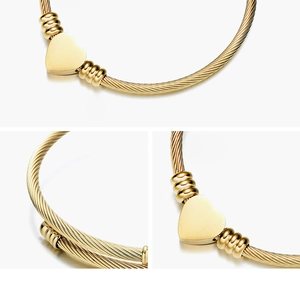 Detailed macro view of 18K gold plated cable wire bracelet with heart charm