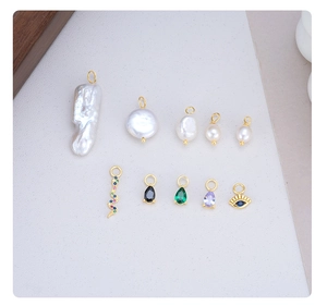 Detailed close-up of Baroque pearls and gold snake charms for DIY jewelry making