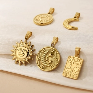 Five assorted 18K gold plated celestial sun and moon pendants on white silk