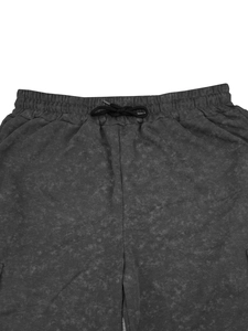 Detail of grey acid wash casual shorts showing the elastic waistband and black drawstring