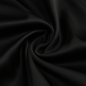 Close-up of premium black satin fabric with elegant drapes and smooth silk texture