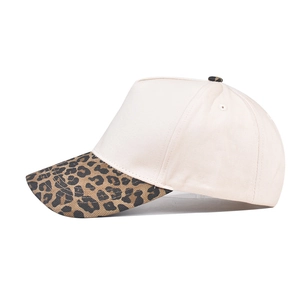 Minimalist cotton baseball cap featuring a cream crown and leopard print brim detail