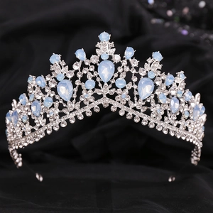 Close-up of Baroque silver bridal crown featuring shimmering blue and clear rhinestones
