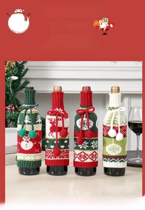 Detail view of knitted Christmas wine bottle covers with reindeer and snowman patterns