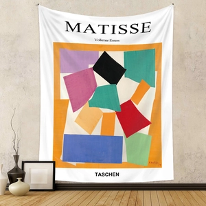 Detail of Matisse style tapestry fabric with vibrant geometric patterns on grey wall
