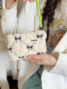 Cream plush bow makeup bag with black diamond embroidery and lime green strap