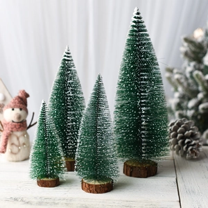 Close-up of four mini green frosted cedar trees with natural wooden bases for table decor